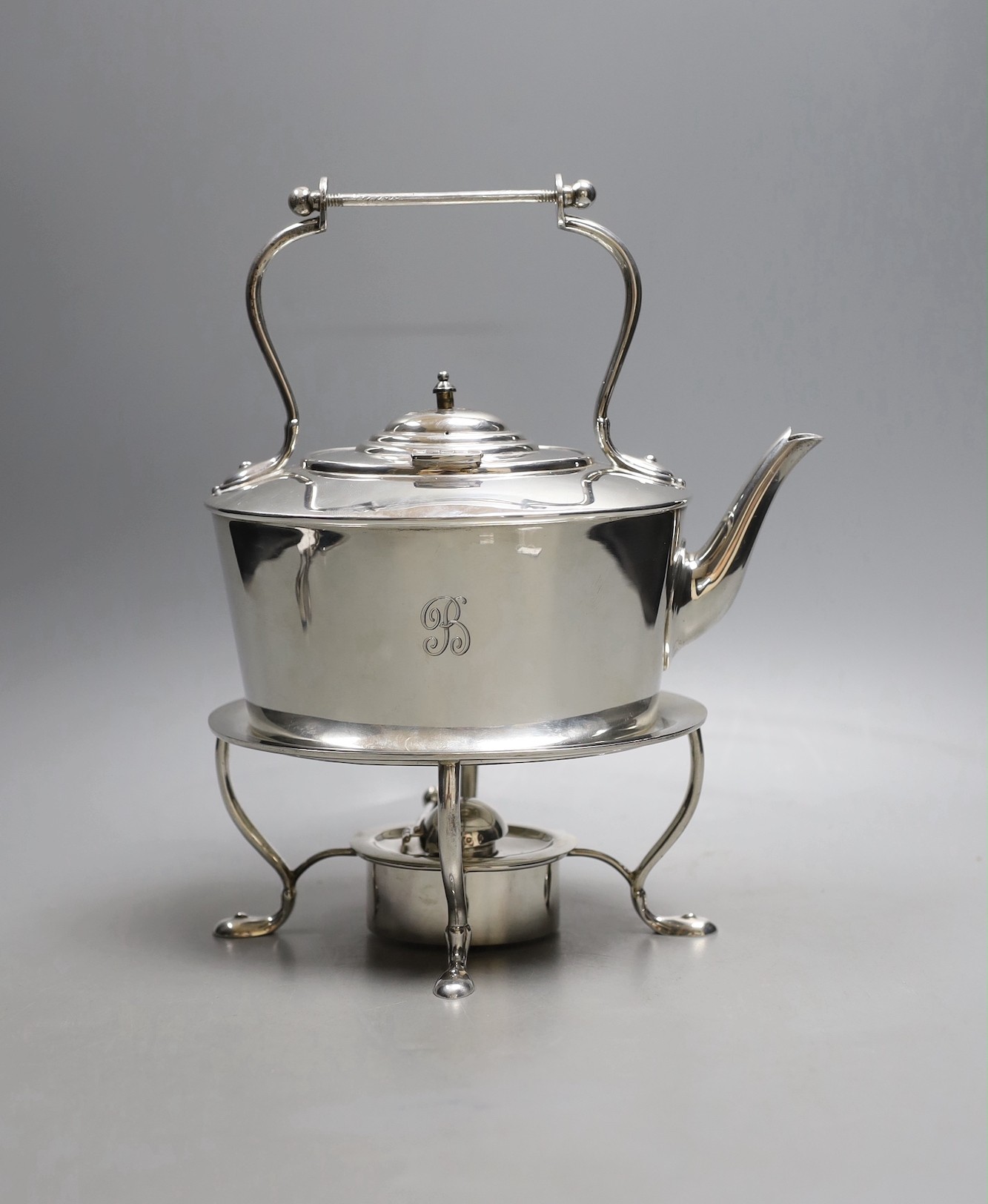 An Edwardian Scottish silver oval tea kettle, on stand with burner, Hamilton & Inches, Edinburgh, 1904, height 25.3, (handle missing), 27.5oz.